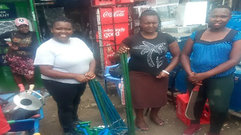 Four women standing in a tool shop.