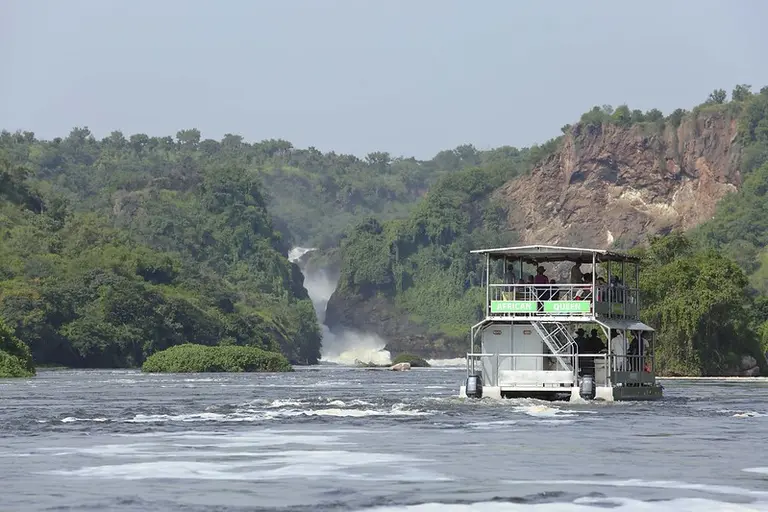 Boat on a lake and a waterfall in the background