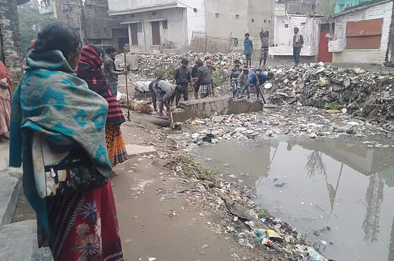 Women looking at a flooded road.