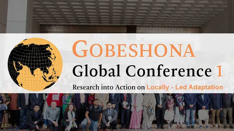A group of people pose for a picture, behind words that say "Gobeshona Global Conference 1"
