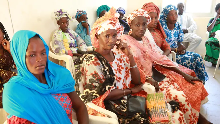 Women taking sitting in chairs
