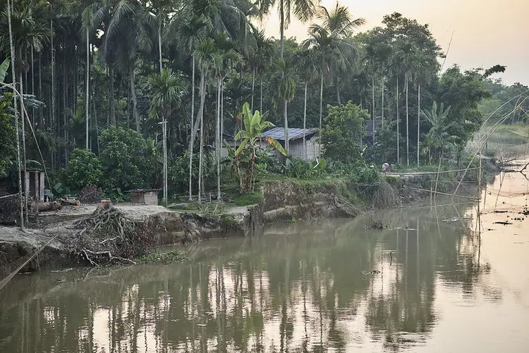 An expanse of water next to a bank of soil