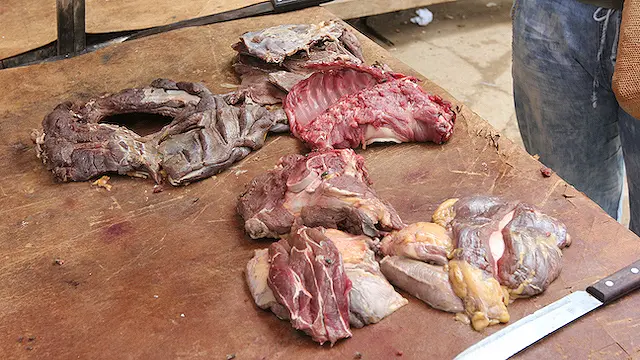 Raw meat and a knife on a table
