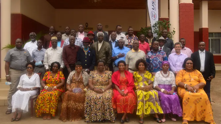Standing and seating men and women pose for a group photograph