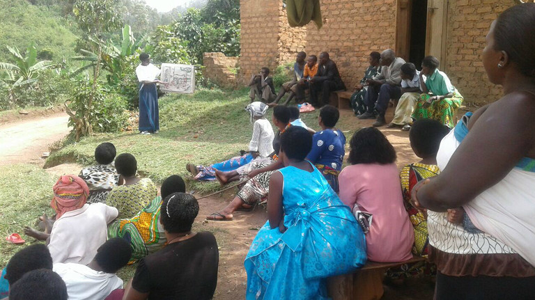 A volunteer health and conservation trainer gives a group talk to her community (Photo: Conservation Through Public Health)