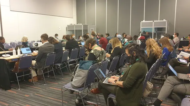 Room full of people sitting down and looking at their laptops