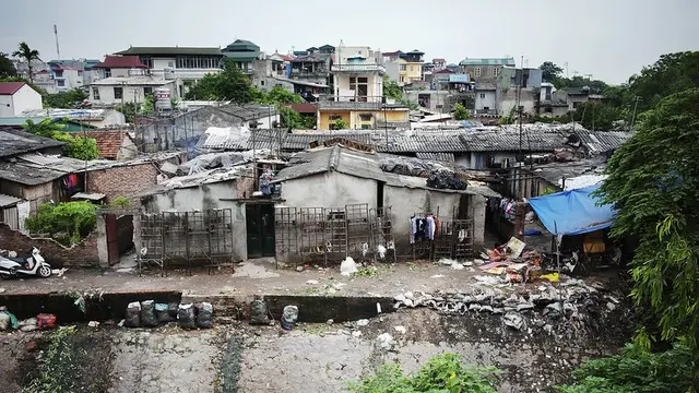Aerial view of informal housing surrounded by garbage.