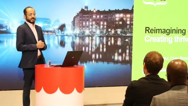 A man stands behind a podium giving a speech,