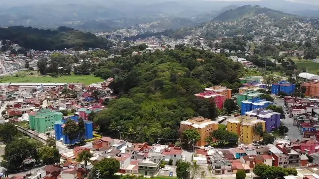 Distance view of an urban landscape with mountain in the background.