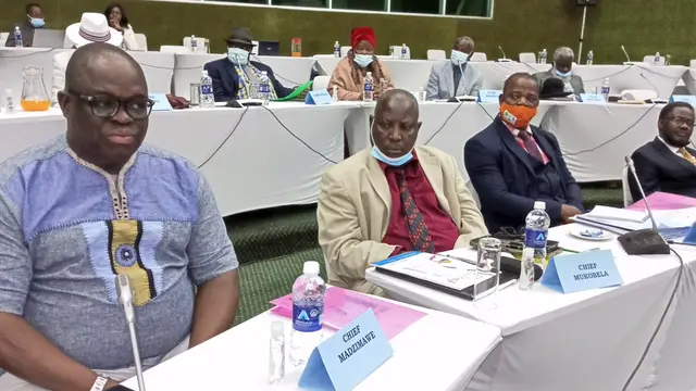 Men sitting at a conference table.
