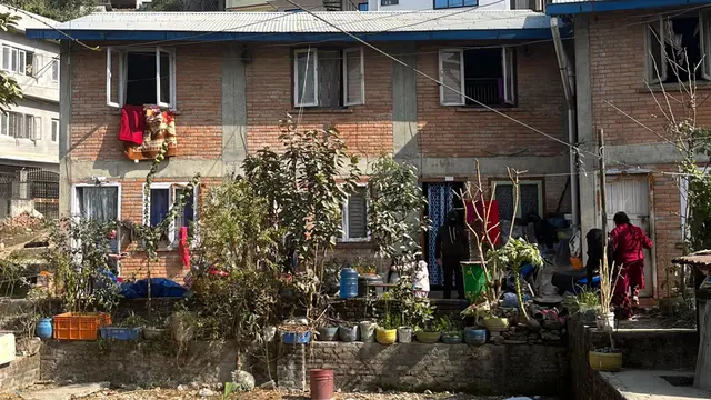 Housing with a small garden in front of the building.