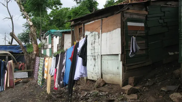 Washing blocks in informal settlements with clothes hang to dry outside.