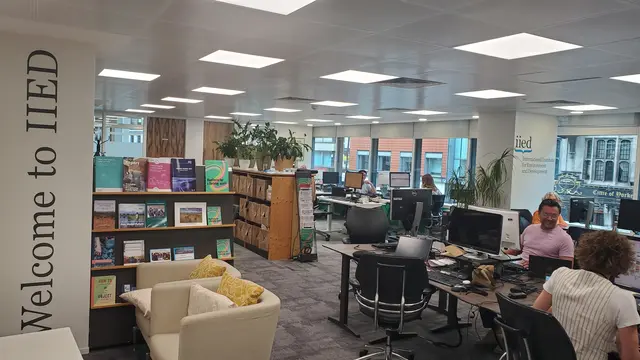 Landscape image of IIED office. Staff can be seen sitting at desks, chatting and laughing.