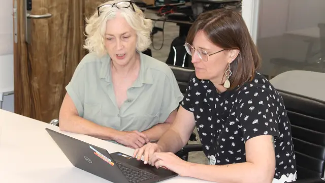 IIED staff members looking at a laptop, discussing