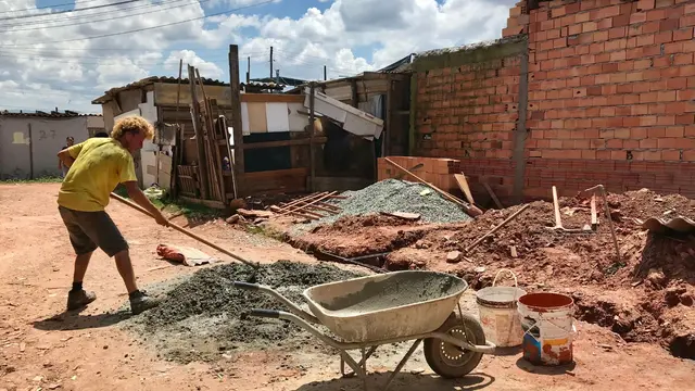 Man moving cement in Ocupação Jorge Hereda, São Paulo.