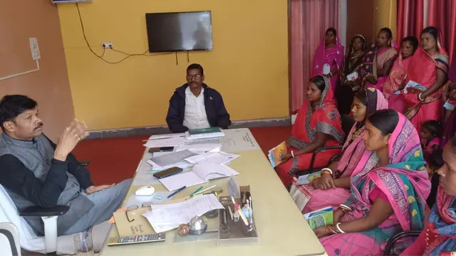 Group of women sitting in the office of a government official, discussing.
