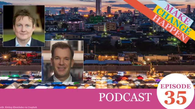 Graphic card containing head and shoulder images of the two podcast speakers, on top of an image of a city at night.