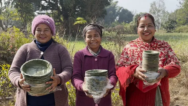 Women displaying their compressed Sal leaf plates.