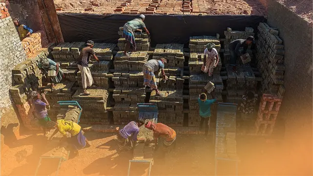 Workers toil to line up thousands of bricks under a hot sun.