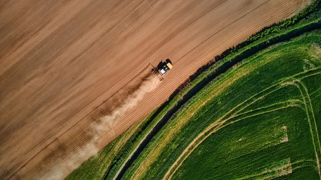 Aerial view of farmer working its fields.