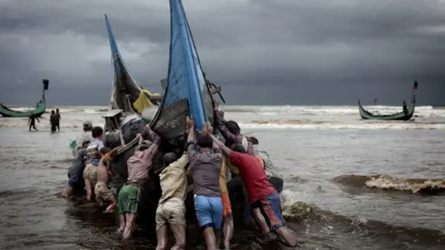 Fishing boats return to a beach on the Bay of Bengal. 