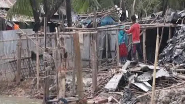 An image of television footage of a man standing instead a destroyed house after Cyclone Roanu hit Bangaldesh (Photo: Google licence)