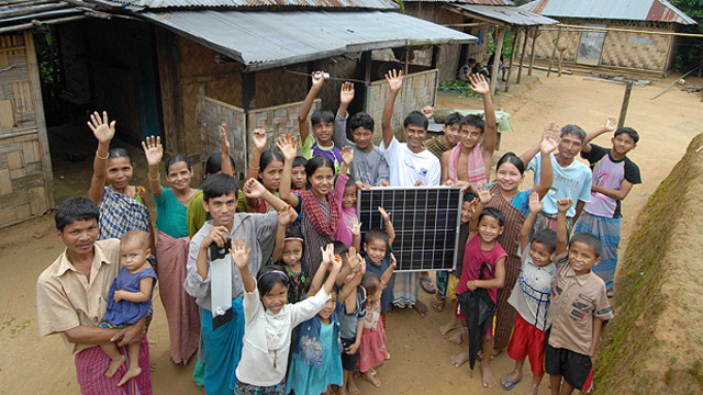 An image of villagers in a remote village in northern Bangladesh proudly displaying their first solar panel, purchased with a micro loan. Bangladesh aspires to be one of the world's largest solar providers (Photo: ILO in Asia and the Pacific, Creative Commons, via Flickr)