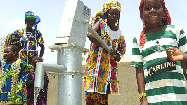 Children using water pump in Burkina Faso