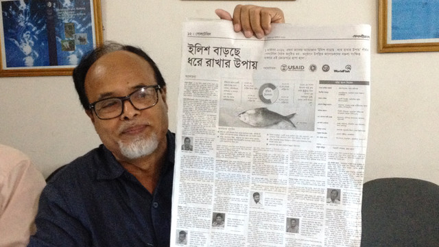 Shahajat Ali shows a newspaper article describing the incentive-based hilsa conservation programme under the Department of Fisheries (Photo: BCAS) 