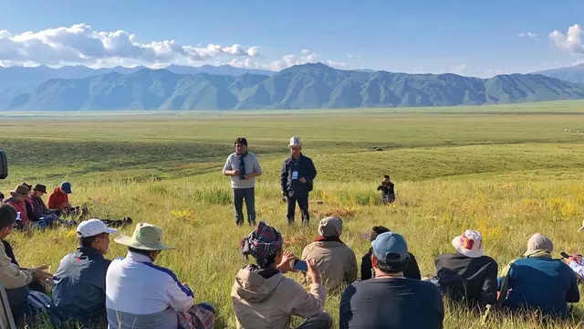 People sitting in a pasture