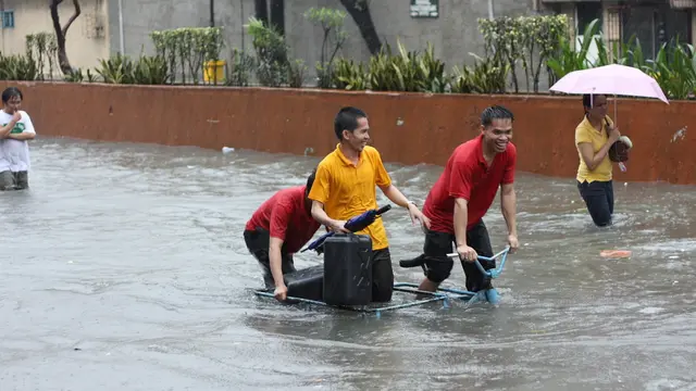 People walking down a flooded road