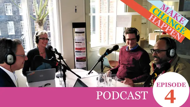 Four people sat around a table speaking into microphones
