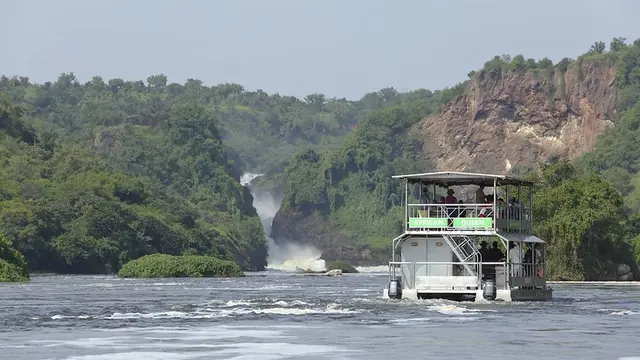 Boat on a lake and a waterfall in the background