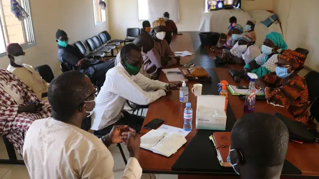 People sitting around a meeting table