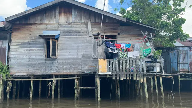 A house on stilts above a body of water.