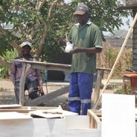 Man painting wooden furniture.