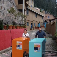 Two people pushing colourful carts.
