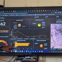 A man showing a slide of an application dashboard.