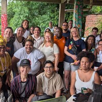 Group photo of participants gathered together, holding snacks.