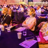 This photo shows audience members listening to the opening plenary speeches.