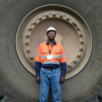 5. Wellington Moses is a dump truck operator at the large-scale Geita Gold Mine. He is proud to operate one of the biggest dump trucks in Tanzania: "It's a beautiful machine!"