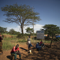 6. Workers sit outside the entrance to the small-scale Nsangano Gold Mine. Up to 20 per cent of the global gold supply is produced by artisanal and small-scale miners