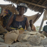 10. Women crush and separate rocks to extract gold ore at Nsangano Gold Mine