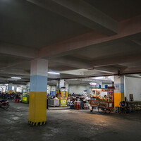 This basement relocation zone does not attract many customers; vendors are frequently at risk of losing their businesses. Onin Heriyani, 45, is one of the vendors relocated from the open alun-alun of the Masjid Raya Mosque, sells warm chicken soup: "Since the relocation the number of customers has declined dramatically and so has my income. I also have to breathe in car and motorcycle fumes, as there is a really poor air circulation in the basement." (Photo: Kemal Jufri/Panos Pictures)