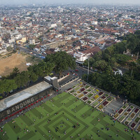 This large open lawn area, the alun-alun, in front of the Masjid Raya Mosque in Bandung is a transformed public space. Once crowded with street vendors, this now a 'red zone'. No street vendors are allowed to set up shop here, although a handful still operate illegally (Photo: Kemal Jufri/Panos Pictures)