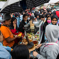 Food vendors serve factory workers at Gempol Sari street, outside the Kahatex textile factory in Bandung's outskirts, despite this being a 'red zone' – no vendors allowed. The majority of customers are low-income factory workers who live in the area (Photo: Kemal Jufri/Panos Pictures)