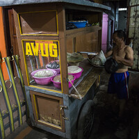 Ato prepares his vending pushcart outside their modest rented home in Bandung. He will leave early to pick a spot in the morning market. Wanti will follow him later to manage the sales (Photo: Kemal Jufri/Panos Pictures)