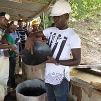 A mineworker shows visitors the gold amalgam processed at the Dakete Gold Mine. Small-scale gold mining can be a source of local sustainable development, but its full potential is seldom realised (Photo: Caroline Digby)